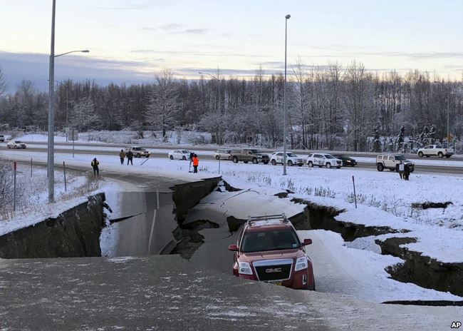 Un auto queda atrapado en una sección colapsada de la rampa de salida de Minnesota Drive en Anchorage, el viernes 30 de noviembre de 2018.