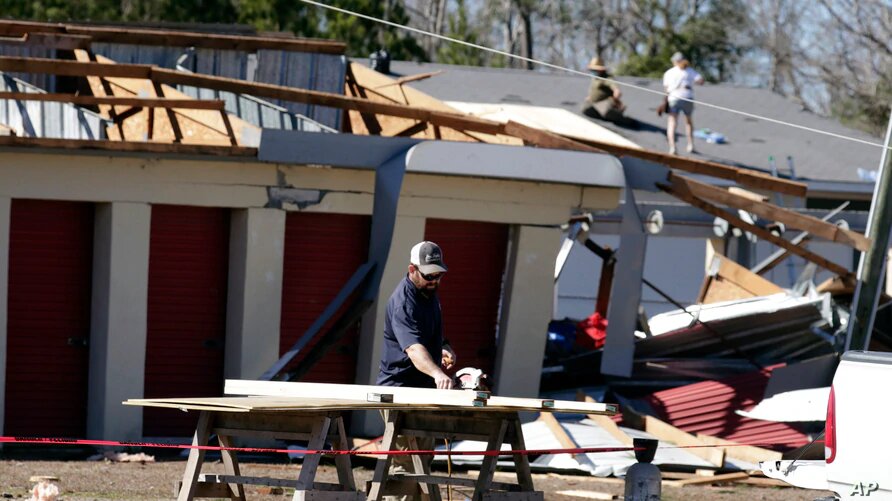 Dueños de propiedades evalúan los daños tras el paso de un tornado cerca de Sunset Beach, Carolina del Norte. | Foto: VOA / AP.