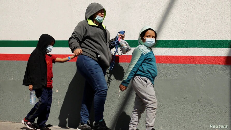 Migrantes centroamericanos en busca de asilo en Estados Unidos que fueron transportados en avión desde Brownsville a El Paso, Texas. Los deportaron de Estados Unidos. En la imagen, cruzan el puente fronterizo internacional Paso del Norte, en Ciudad Juárez, México, el 19 de marzo de 2021. | Foto: Reuters / VOA.