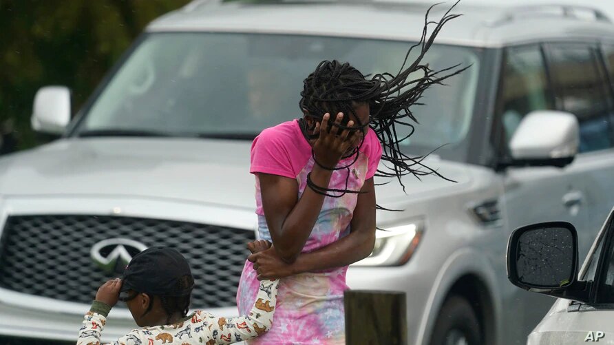 Una niña cubre su rostro del viento y la lluvia producidos por el huracán Ida, el domingo 29 de agosto de 2021, en Nueva Orleans, Estados Unidos. | Foto: AP / VOA.